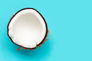Half coconut on blue background.