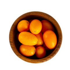 cumquat in wooden bowl isolated on white