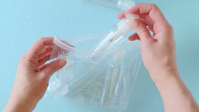 a woman takes plastic bottles from a bag, view from above