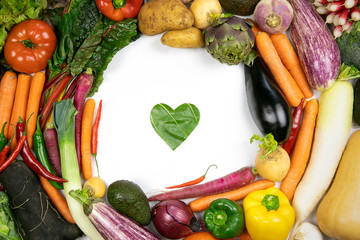 Various vegetables flat lay frame with green leaf heart love symbol inside. Healthy lifestyle concept. Top view.