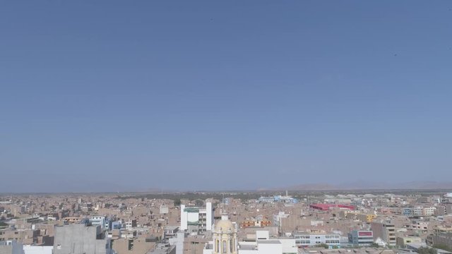 Pullback aerial drone view move of the towers of the Cathedral at the main square of Chiclayo city in Lambayeque Region, Peru