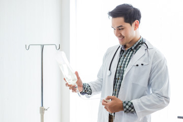 Portrait of Asian Young man doctor therapeutic advising smiling face with stethoscope holding with...