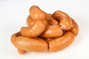 Tasty meat sausages over white background