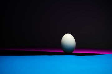 The eggs are in black, blue, pink background. Easter Egg Concept and Dark Concept