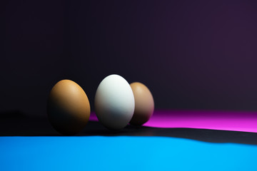 many eggs are in Colorful ( black, blue, pink ) background. Easter Egg Concept and Dark Concept