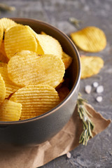 potato chips in a gray bowl on a gray background