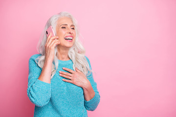 Portrait of positive cheerful old woman use smartphone call her friend hear jokes laugh put hands...
