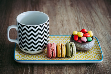 Goûter avec des macarons colorés et du café