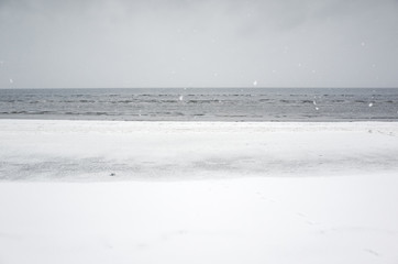Winter coastal landscape with ice, snow and sea