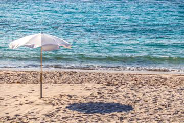 A single parasol on a beach