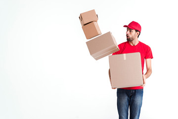 Courier man drops the parcel post boxes and looking afraid