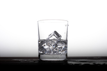 Clear alcohol in a glass with ice