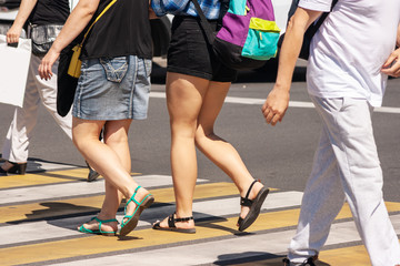 Fototapeta na wymiar pedestrians crossing the road at a crosswalk in the city