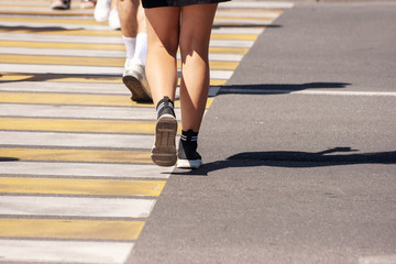 woman crossing the road at a crosswalk