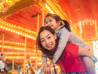Velvet curtains Amusement parc happy asia mother and daughter have fun in amusement carnival park with farris wheel and carousel background