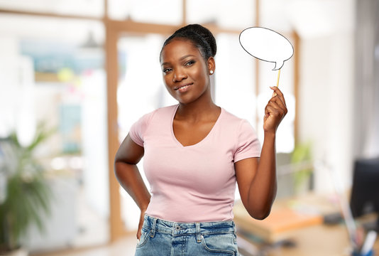 Party Props, Photo Booth And Communication Concept - Happy African American Young Woman Holding Blank Speech Bubble Over Office Background