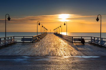 Beautiful landscape with wooden pier in Gdynia Orlowo at sunrise, Poland