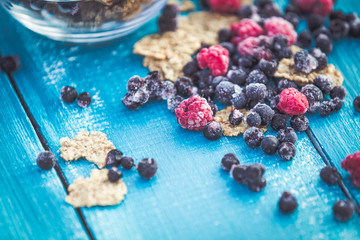 Organic cereals on blue wooden background