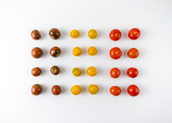 Varieties of cherry tomatoes in line isolated on white background, abstraction