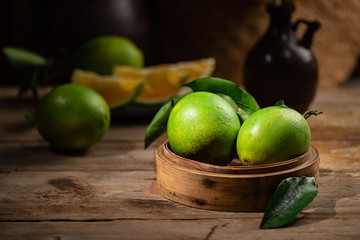 Beautiful color of green orange, on the  wooden table indoor