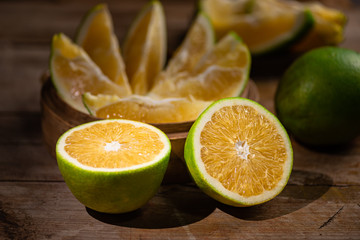 Beautiful color of green orange, on the  wooden table indoor