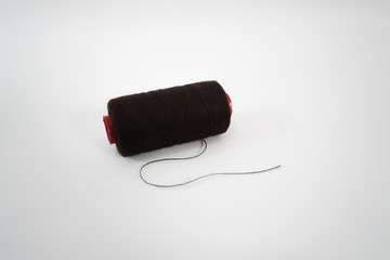 brown sewing thread on a white background