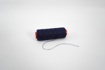 blue sewing thread on a white background