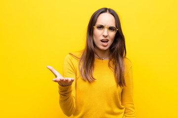 young pretty woman looking angry, annoyed and frustrated screaming wtf or what‚Äôs wrong with...