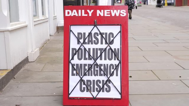 4K: Newspaper Headline Board About Plastic Pollution Crisis - News Stand. Stock Video Clip Footage