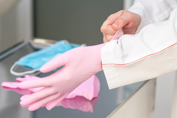 Close up putting on latex gloves.