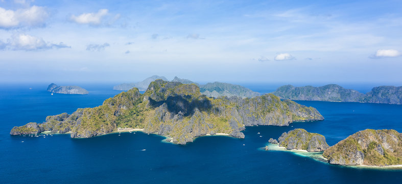 View from above, stunning aerial view of the Big Lagoon and the Small Lagoon, two beautiful bays of crystal clear water surrounded by rocky cliffs. Bacuit Bay, El Nido, Palawan, Philippines.