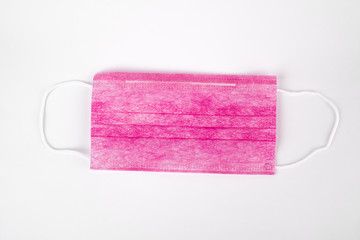 Obraz premium Medical pink mask on a white background