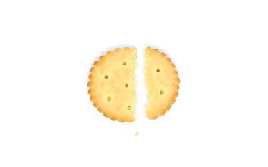 one round cracker broken into two parts isolated on white background