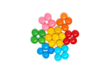 flower of many colored small round candies isolated on a white background