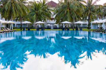 Sunbathing deck with umbrella swimming pool hotel resort beach panoramic sea view blue background.