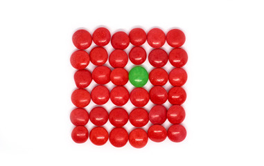 background many red and one green candy