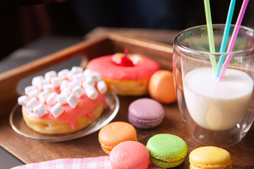 donut with pink marshmallows and macaroons with milkshake
