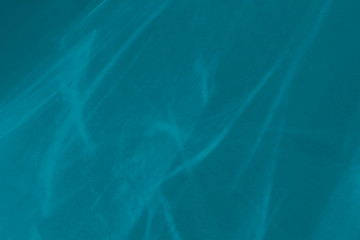 Trendy blue colored abstract background with light and shadows caustic effect. Light passes through a glass, water texture overlay