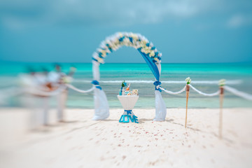 Wedding arch and musicians on the beach, artistic blur, lensbaby