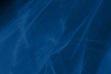 Trendy blue colored low contrast abstract background with light and shadows caustic effect. Light passes through a glass. Water background. 2020 year color trend