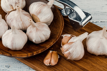 Garlic on a rustic table in a wooden bowl. Fresh peeled garlic.
