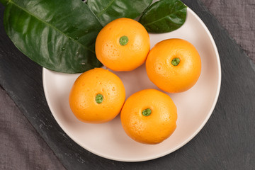 Pork dumpling in cartoon style,Pork bun like an orange in a white plate on the indoor dining table