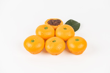 Pork dumpling in cartoon style,Pork bun like an orange in a white plate on the indoor dining table