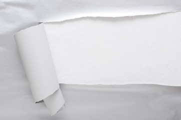 Top view of torn grey paper and empty white space fro design.Concept of wrapping and opening gift, parcels