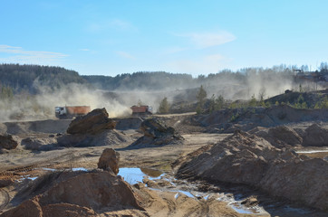 Dump truck transports sand and other minerals in the mining quarry.