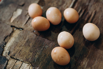 chicken eggs on brown wooden background