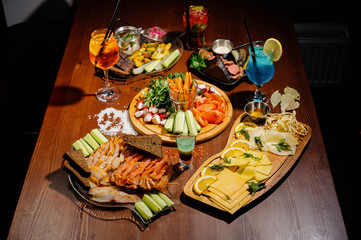 Many different delicious dishes on the table. Various snacks and antipasti on the table. Restaurant menu.