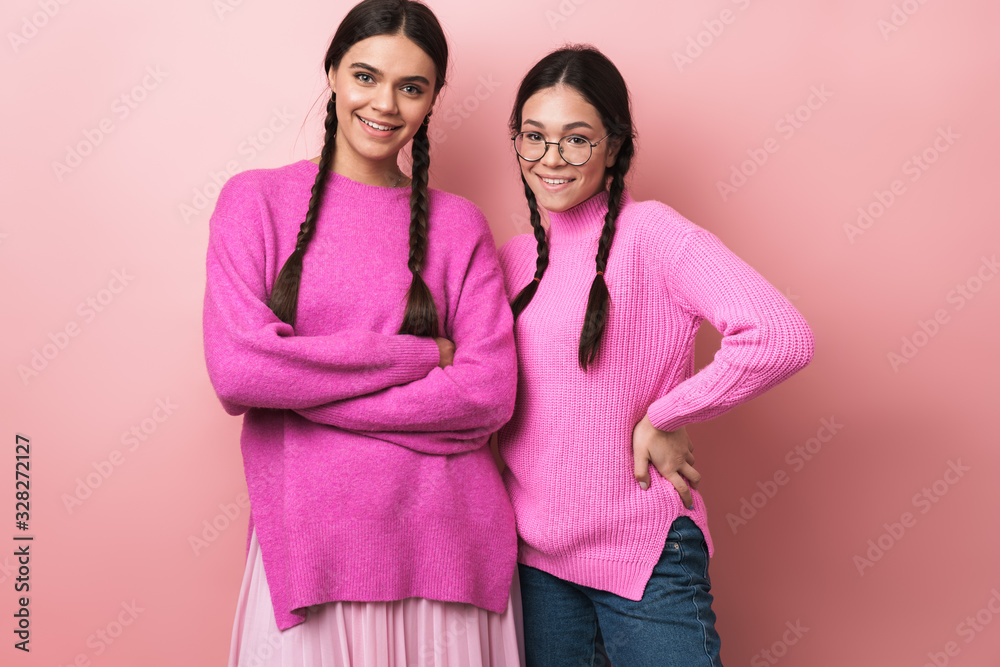 Sticker image of two happy teenage girls in casual clothes smiling at camera