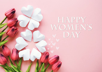 Happy Women's Day Wishes card - paper hearts shape figure eight 8 on soft pink background and bouquet of purple tulips