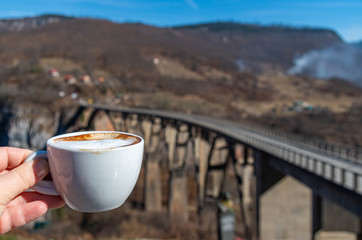 Cup of Coffee on Background of Sky and Mountains